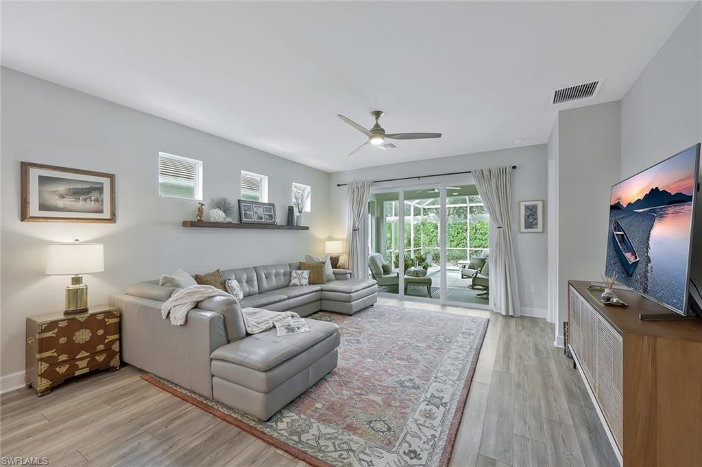 10787 Manatee Key Lane Estero, FL 33928 - Photo 6 of 31 a living room with furniture and a flat screen tv