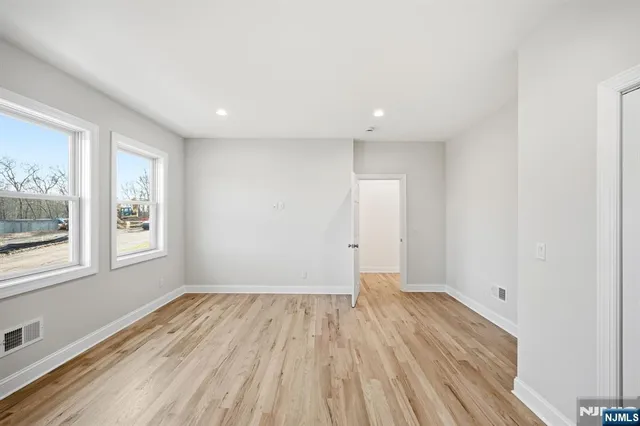 a view of a room with wooden floor and window