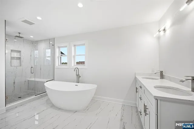 a spacious bathroom with a bathtub and shower