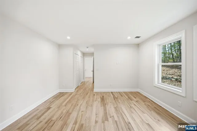 a view of room with window and wooden floor