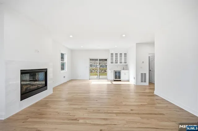 a view of an empty room with a window and fireplace