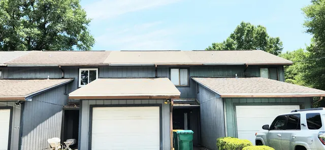 a view of a patio with table and chairs under an umbrella