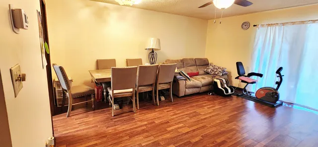 a living room with furniture and a wooden floor