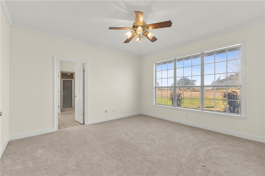 2120 Hohenwalde School Road Brenham, TX 77833 - Photo 15 of 30 an empty room with chandelier fan and windows