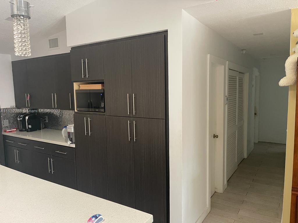 1115 North Park Road Hollywood, FL 33021 - Photo 3 of 6 a kitchen with a refrigerator and cabinets