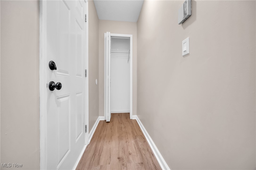6818 Warner Road Madison, OH 44057 - Photo 22 of 29 Corridor with light hardwood / wood-style floors
