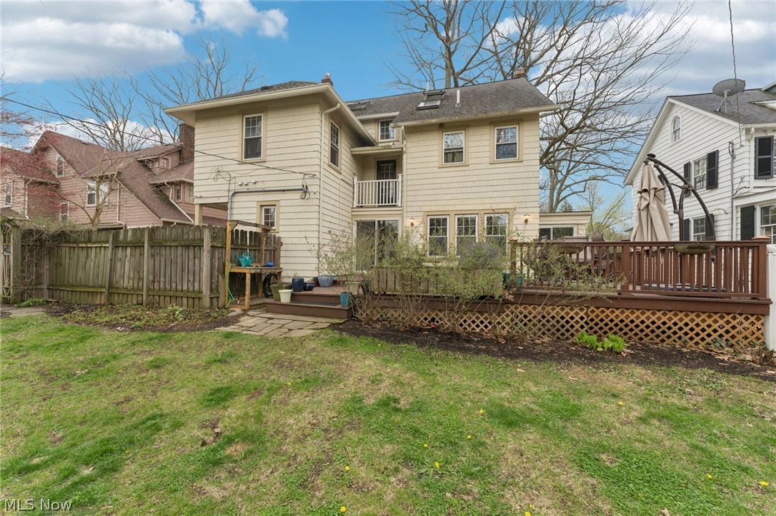 2925 East Overlook Road Cleveland Heights, OH 44118 - Photo 39 of 48 The property features a spacious rear yard with a green lawn, a wooden fence, and a multi-level wooden deck