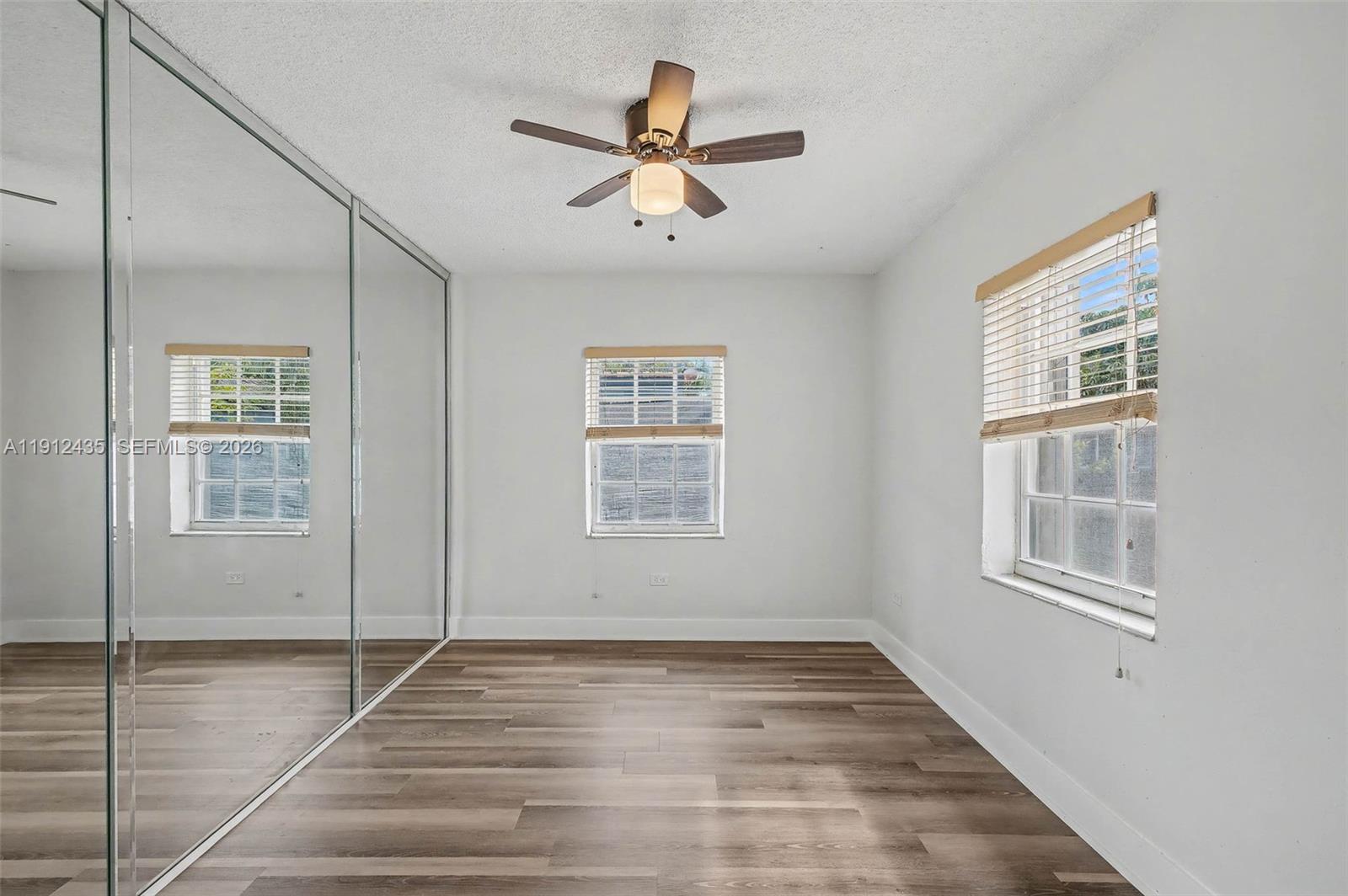 5936 Southwest 29th Street Miami, FL 33155 - Photo 18 of 32 a view of empty room with wooden floor and fan