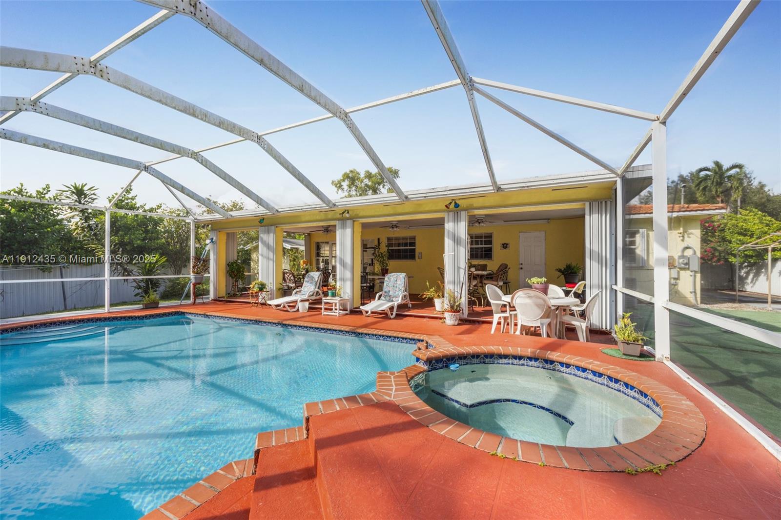 5936 Southwest 29th Street Miami, FL 33155 - Photo 2 of 8 a view of a swimming pool with a patio