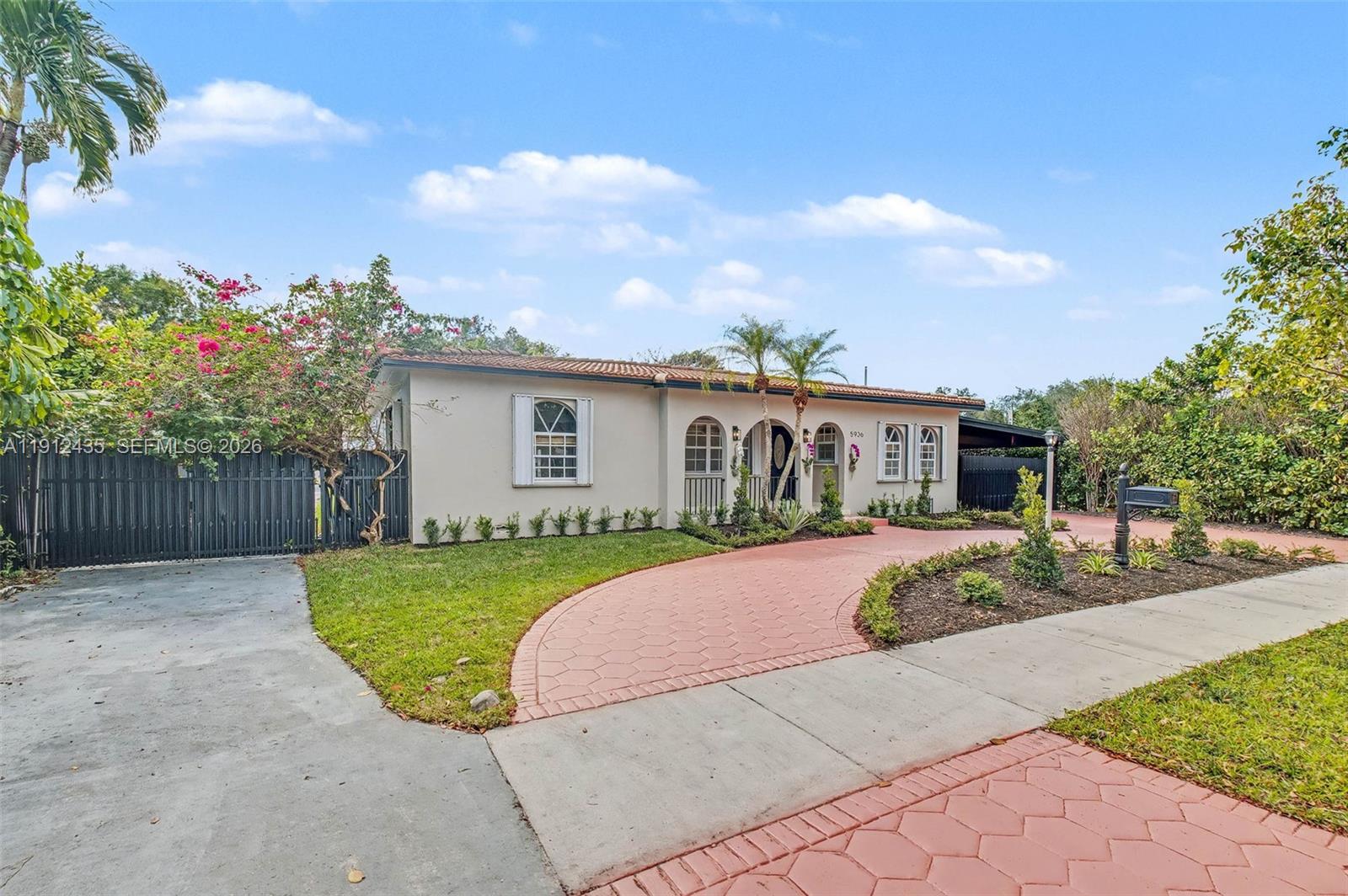 5936 Southwest 29th Street Miami, FL 33155 - Photo 2 of 32 a front view of house with yard and trees in the background