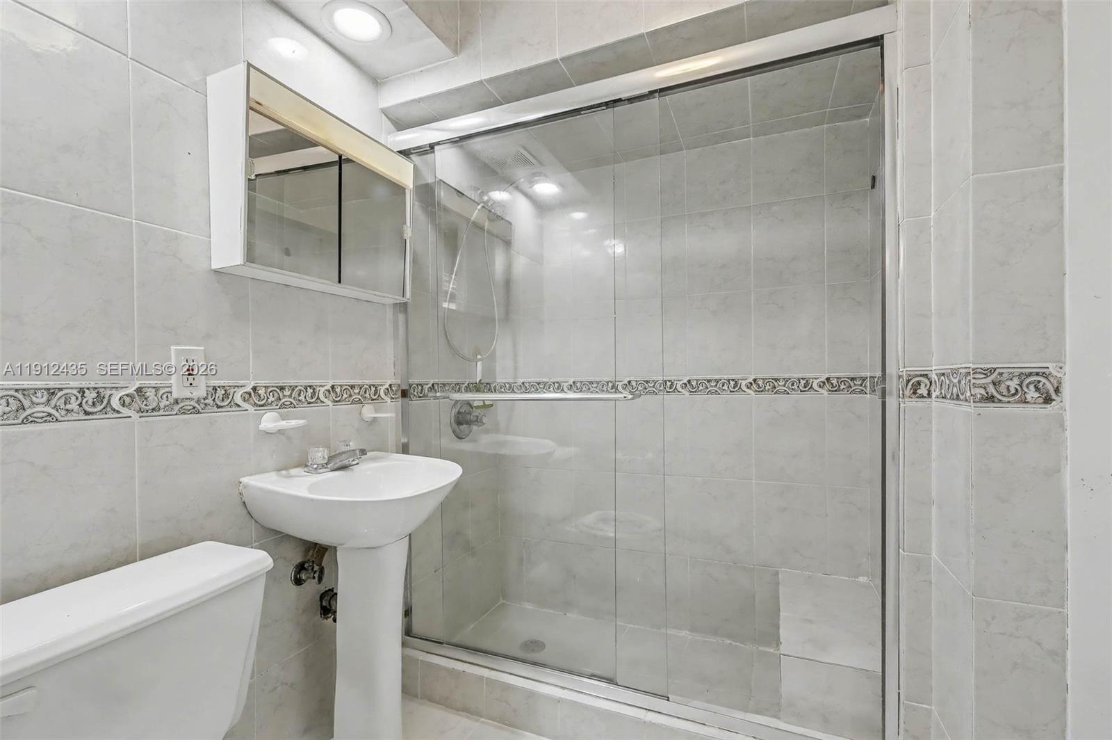 5936 Southwest 29th Street Miami, FL 33155 - Photo 21 of 32 a bathroom with a sink a toilet and shower