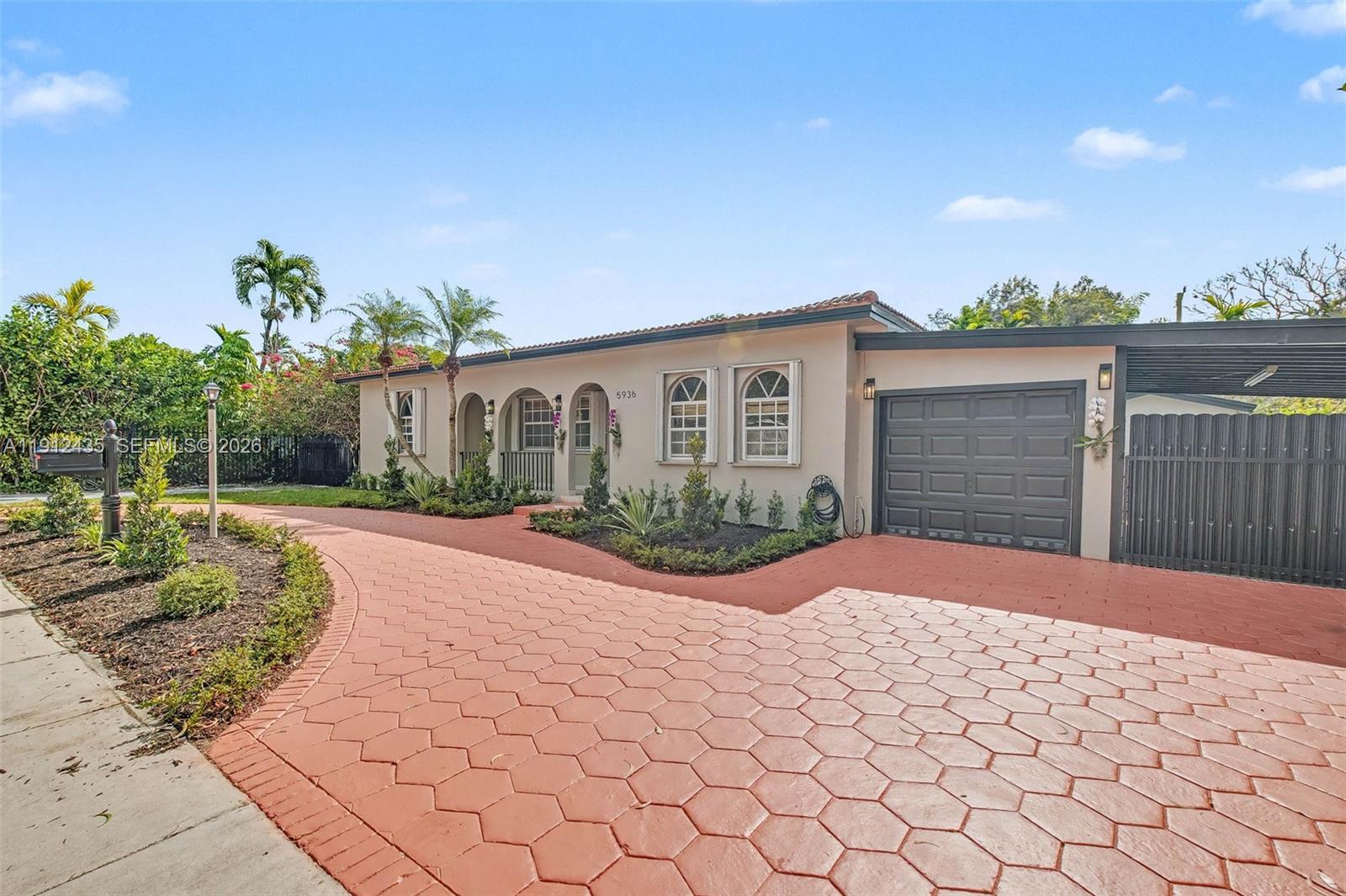 5936 Southwest 29th Street Miami, FL 33155 - Photo 3 of 32 a front view of a house with a yard and potted plants