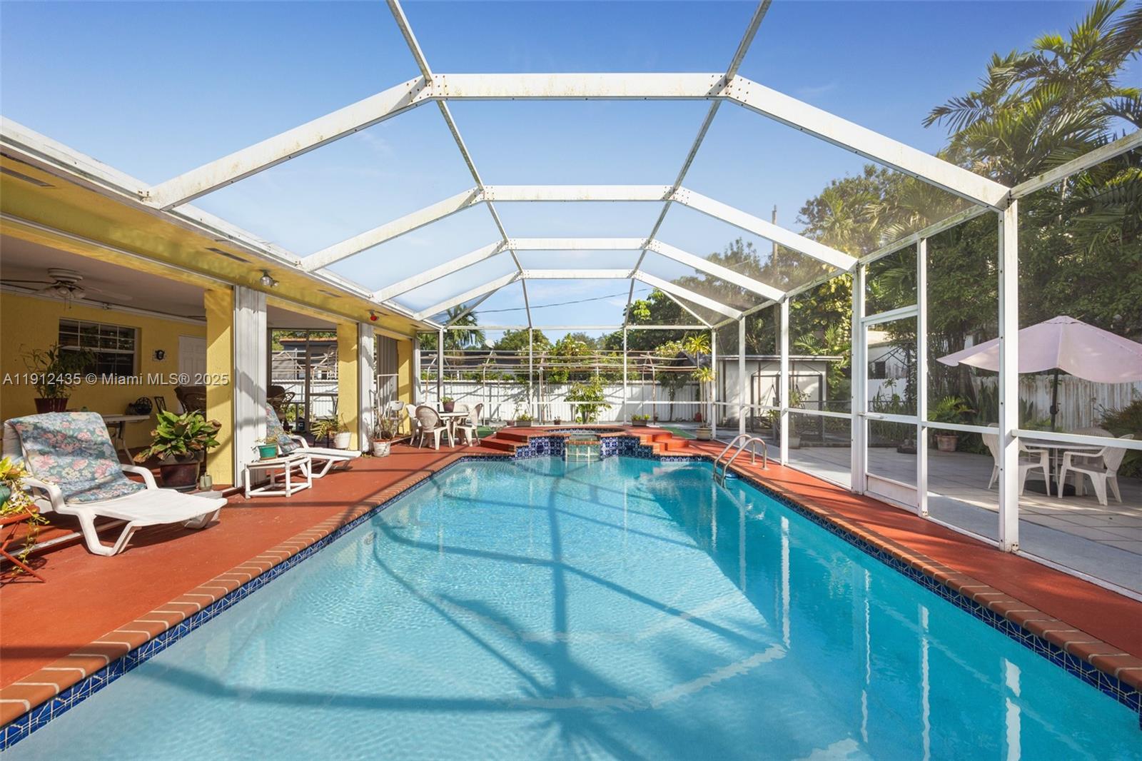 5936 Southwest 29th Street Miami, FL 33155 - Photo 3 of 8 a room with lots of potted plants