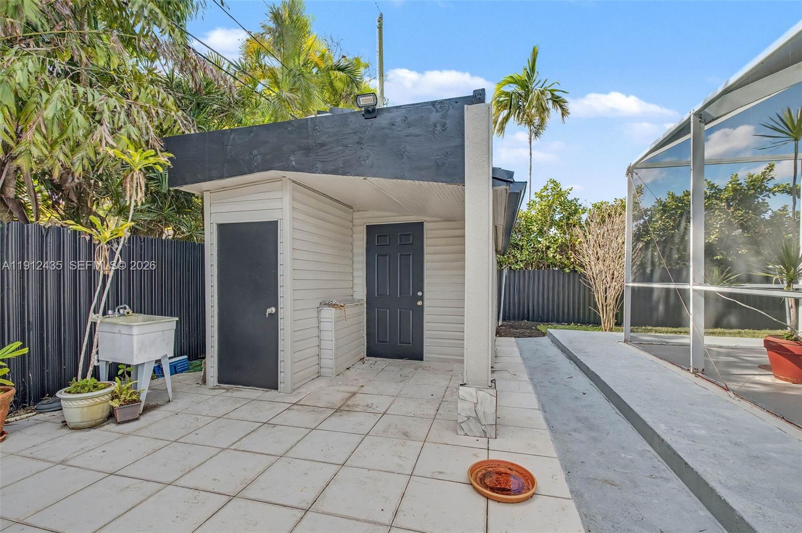 5936 Southwest 29th Street Miami, FL 33155 - Photo 31 of 32 a backyard of a house with seating space