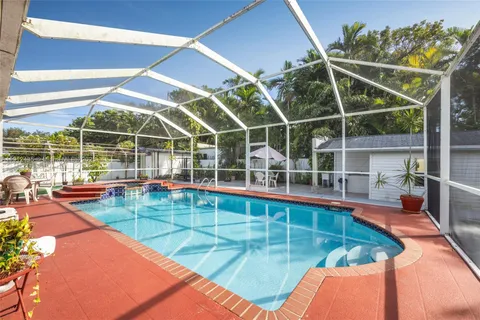 a view of a backyard with a swimming pool
