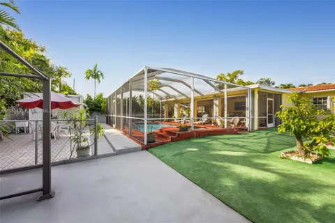 a view of a house with backyard porch and sitting area