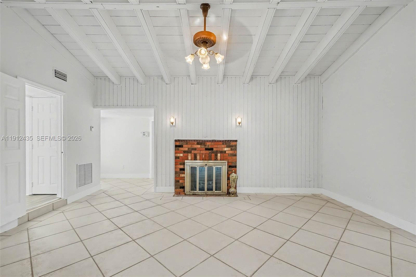 5936 Southwest 29th Street Miami, FL 33155 - Photo 6 of 32 wooden floor in an empty room with a window