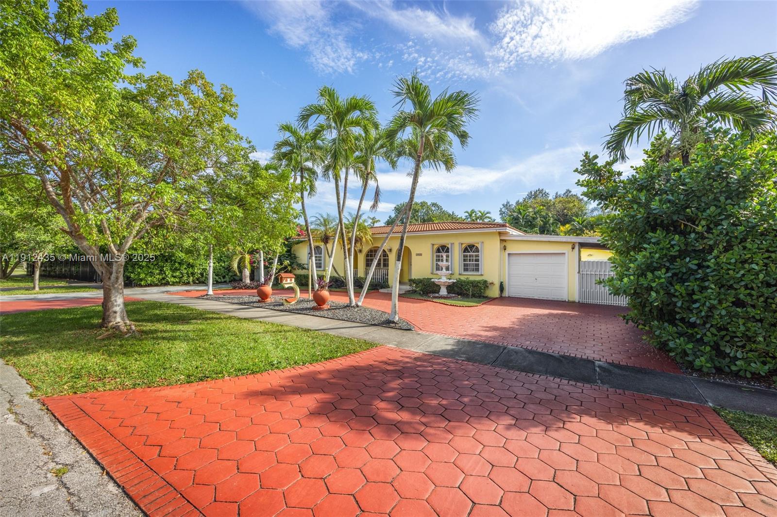 5936 Southwest 29th Street Miami, FL 33155 - Photo 7 of 8 a front view of a house with a yard and a garden