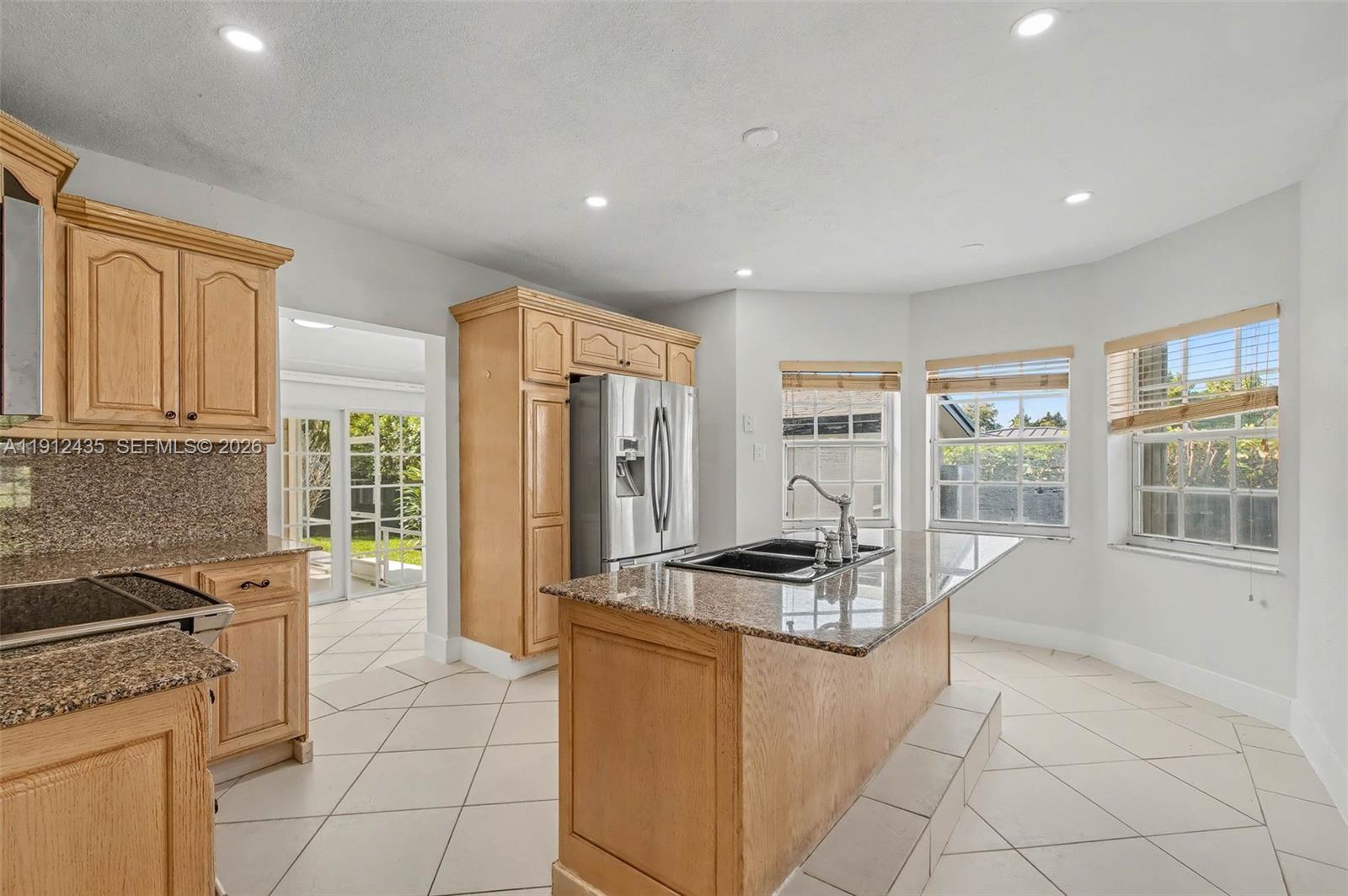 5936 Southwest 29th Street Miami, FL 33155 - Photo 8 of 32 a kitchen with stainless steel appliances granite countertop a stove and a refrigerator