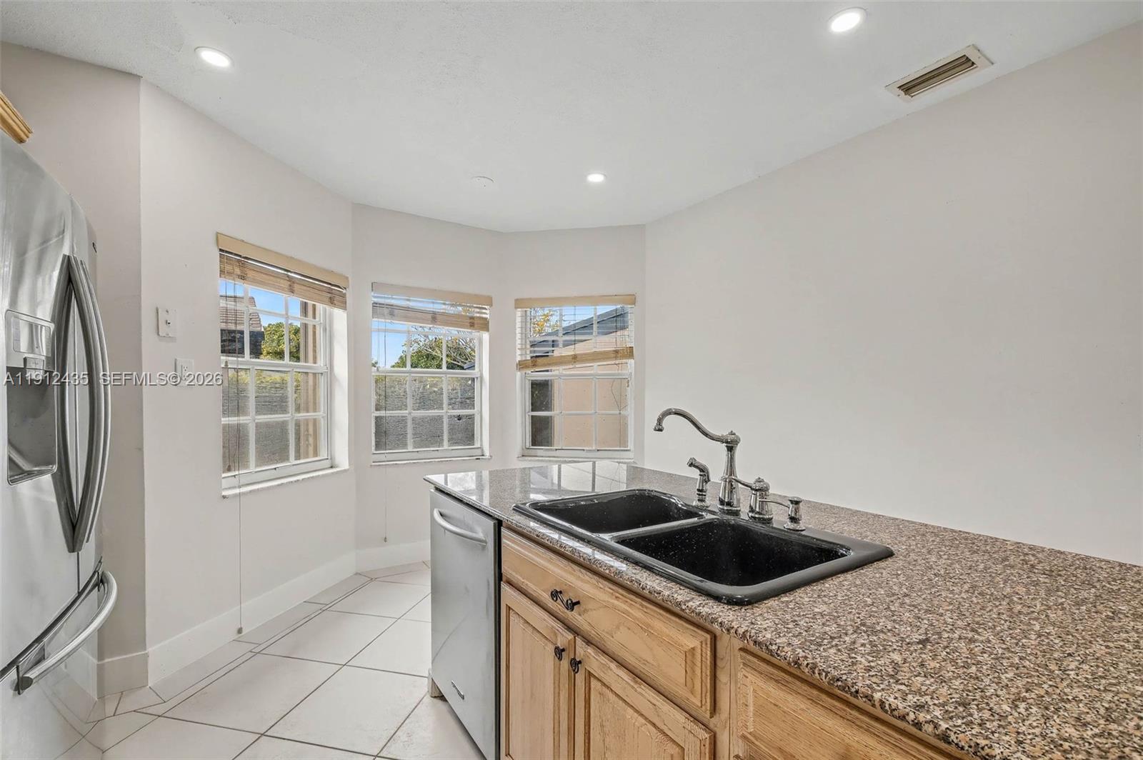 5936 Southwest 29th Street Miami, FL 33155 - Photo 10 of 32 a kitchen with stainless steel appliances granite countertop a sink and a stove