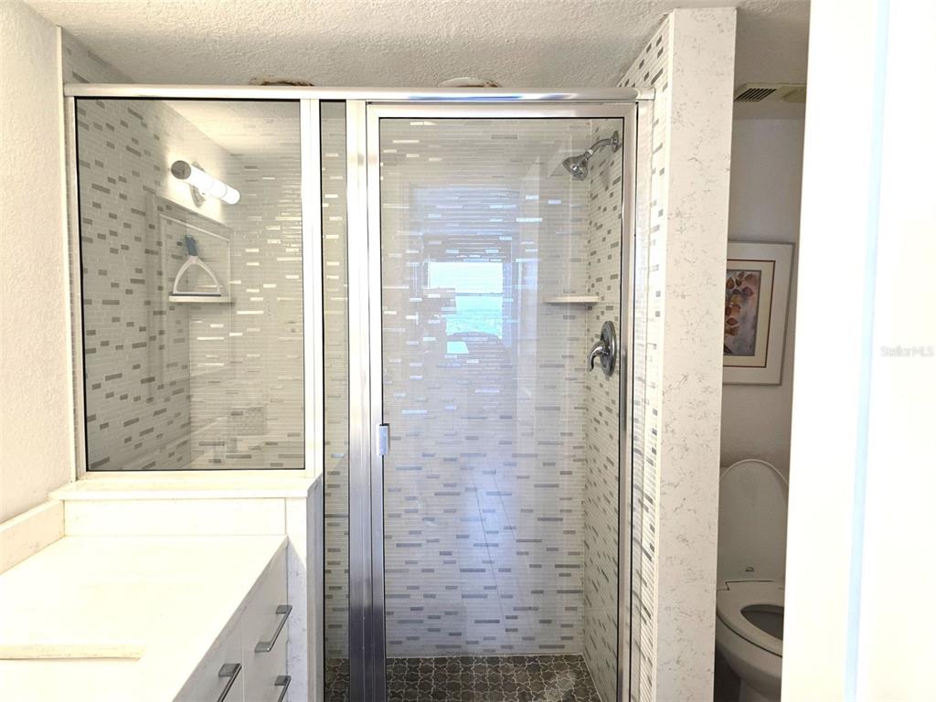 17408 Gulf Boulevard, Unit 1003 Redington Shores, FL 33708 - Photo 11 of 28 a bathroom with a shower