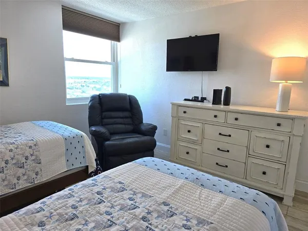 a bedroom with a large bed and a couch