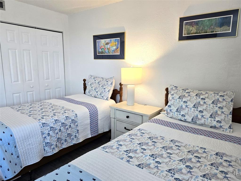 17408 Gulf Boulevard, Unit 1003 Redington Shores, FL 33708 - Photo 16 of 28 a bedroom with a large bed and a couch