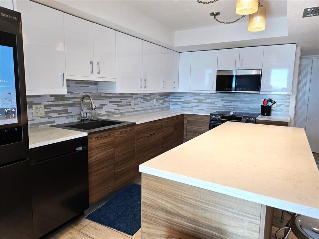 17408 Gulf Boulevard, Unit 1003 Redington Shores, FL 33708 - Photo 18 of 28 a kitchen with a sink and a stove top oven