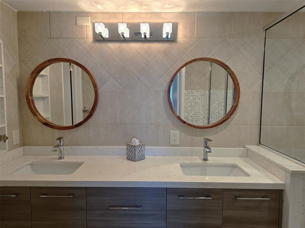 17408 Gulf Boulevard, Unit 1003 Redington Shores, FL 33708 - Photo 24 of 28 a bathroom with a sink and a mirror
