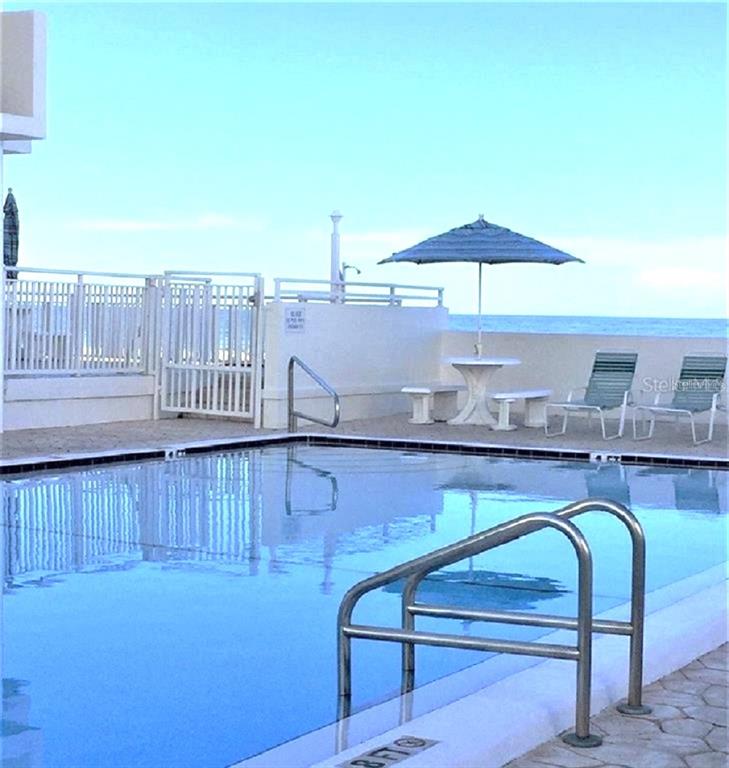 17408 Gulf Boulevard, Unit 1003 Redington Shores, FL 33708 - Photo 26 of 28 an outdoor sitting area with an umbrella