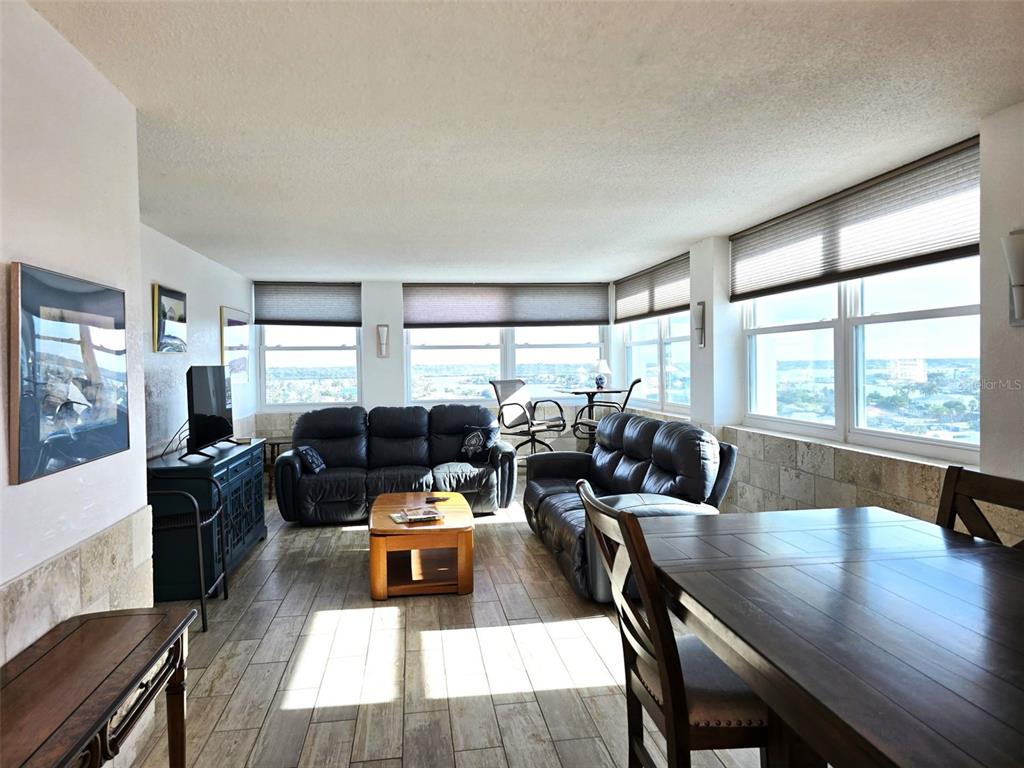 17408 Gulf Boulevard, Unit 1003 Redington Shores, FL 33708 - Photo 5 of 28 a living room with furniture large window and wooden floor