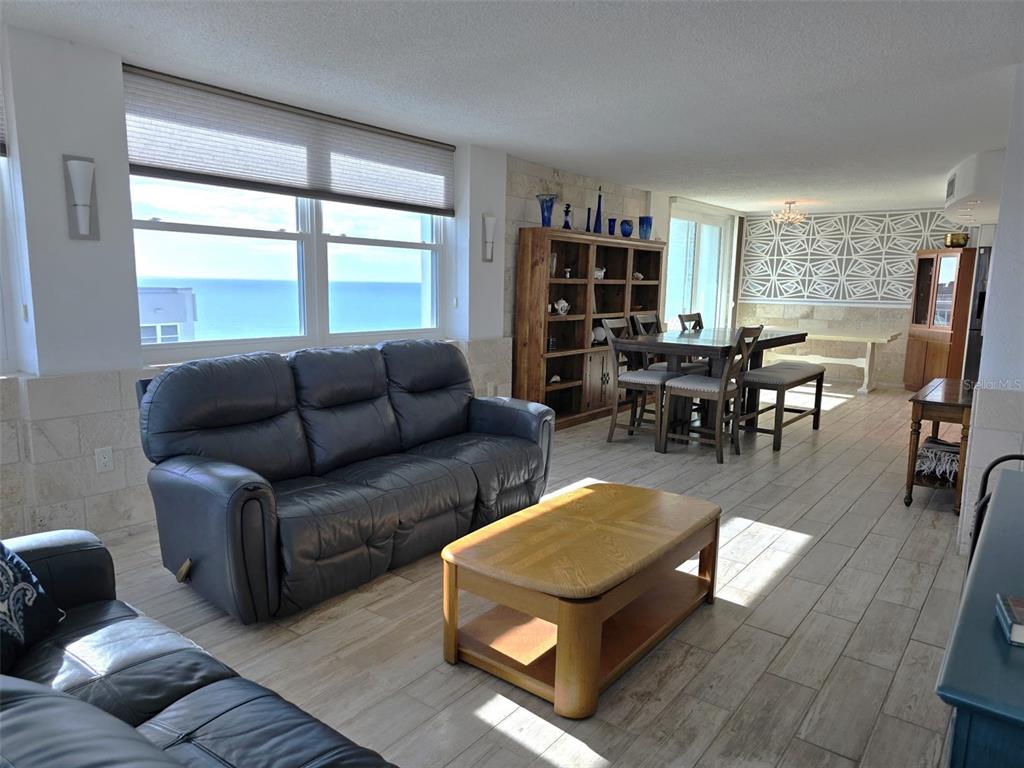 17408 Gulf Boulevard, Unit 1003 Redington Shores, FL 33708 - Photo 7 of 28 a living room with furniture and a large window