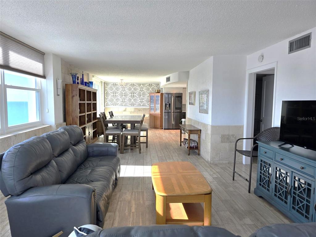 17408 Gulf Boulevard, Unit 1003 Redington Shores, FL 33708 - Photo 8 of 28 a living room with furniture and a flat screen tv