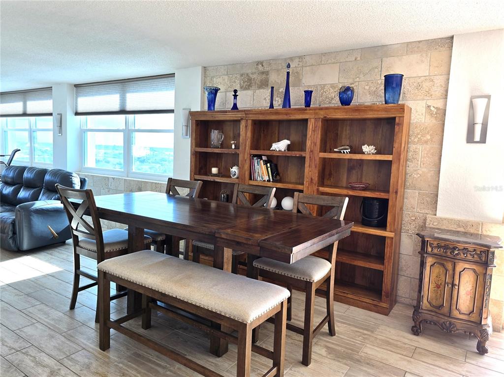 17408 Gulf Boulevard, Unit 1003 Redington Shores, FL 33708 - Photo 9 of 28 a view of a dining room with furniture a rug and wooden floor