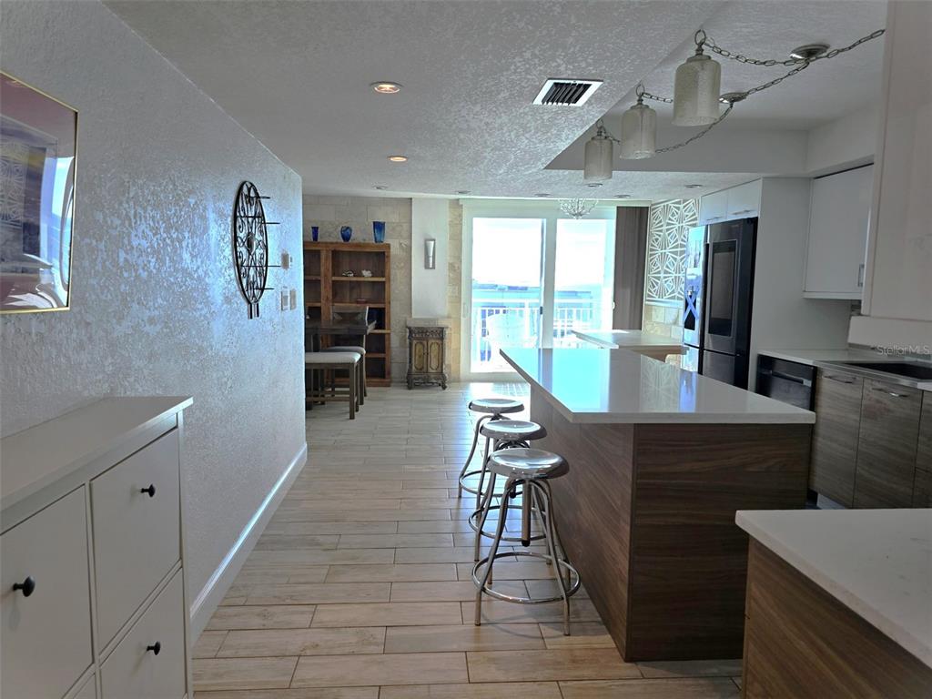 17408 Gulf Boulevard, Unit 1003 Redington Shores, FL 33708 - Photo 10 of 28 a view of a kitchen with workspace and windows