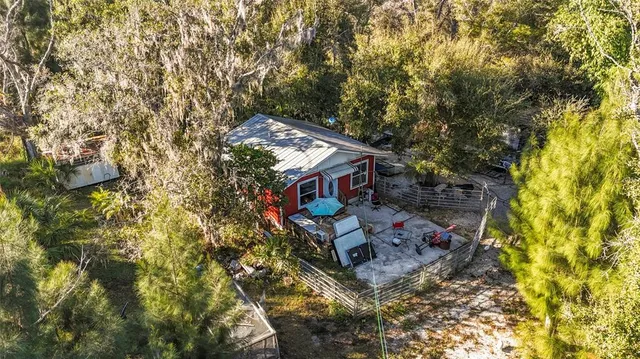 an aerial view of a house with swimming pool and sitting area