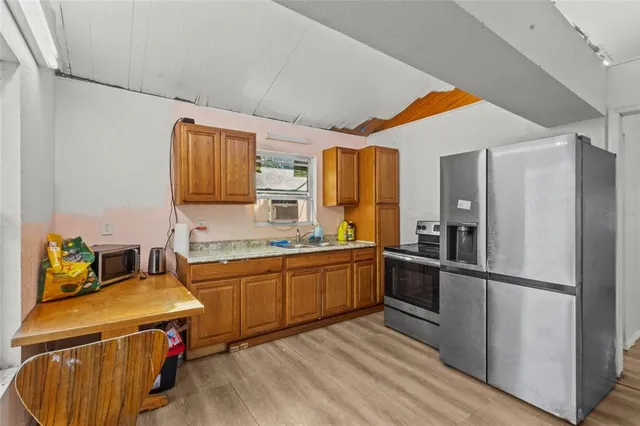 a kitchen with a sink appliances and cabinets