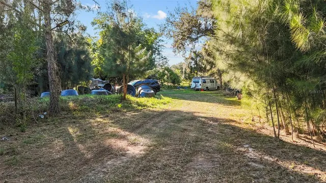 a view of a yard with swimming pool