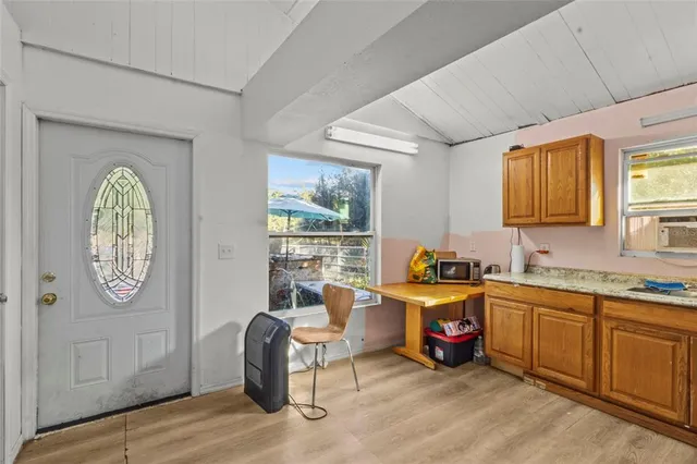 a view of a kitchen with fridge and window