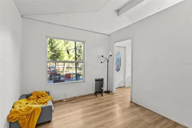 a view of a livingroom with wooden floor and a window