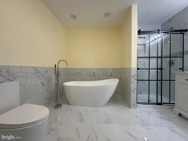 a bathroom with a bathtub and shower