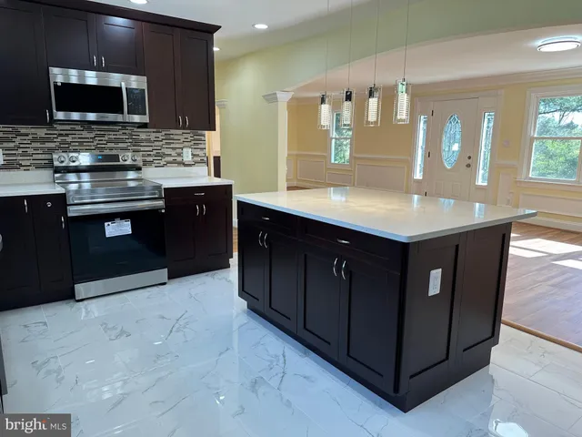a kitchen with a sink and a refrigerator