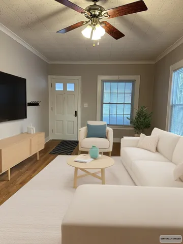 a living room with furniture and a flat screen tv