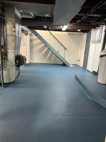 a view of water heater room with stove