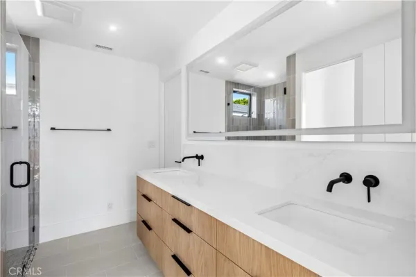 a bathroom with a double vanity sink mirror and