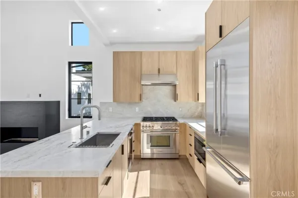 a kitchen with a sink stove and refrigerator