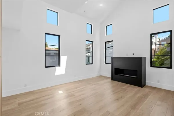 a view of an empty room with a fireplace and a window