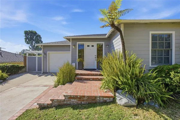 a front view of a house with garden