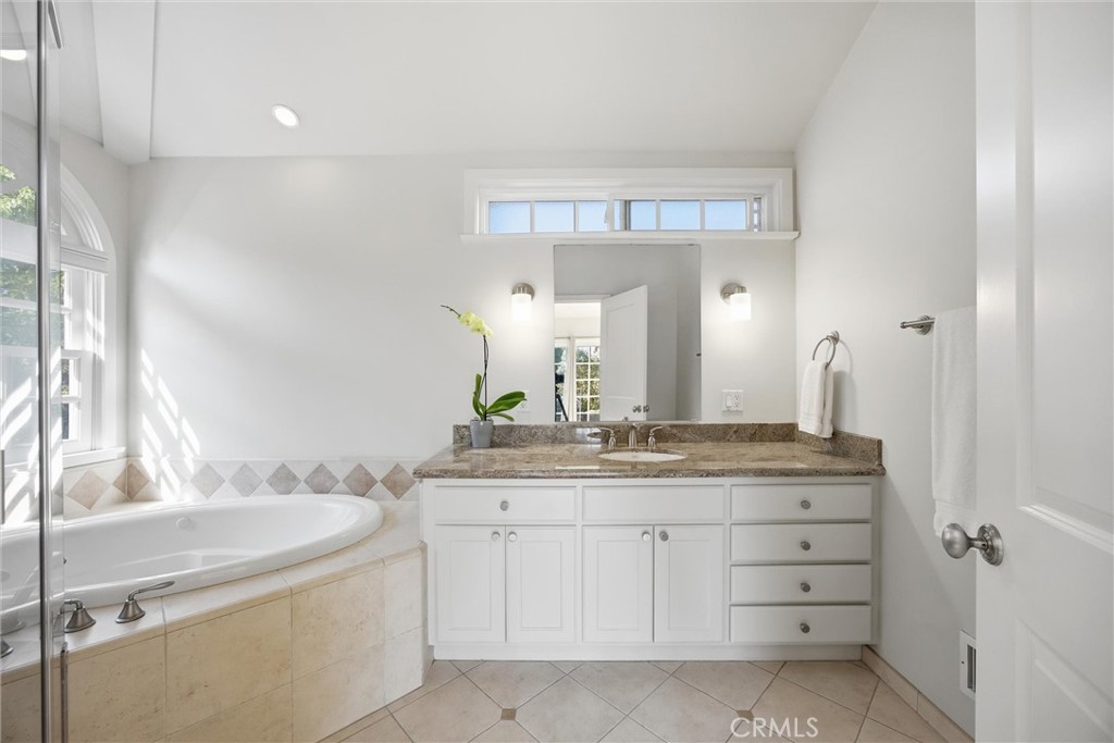 3513 May Street Los Angeles, CA 90066 - Photo 15 of 34 a bathroom with a granite countertop sink a large mirror and a vanity