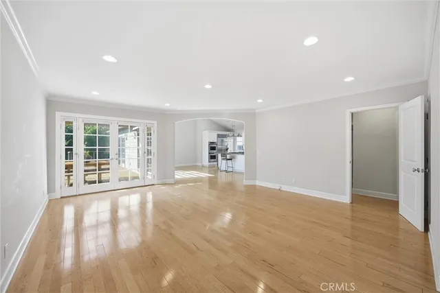a view of a livingroom with wooden floor and a window